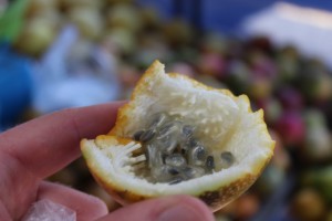 This is a Granadilla, it's small and orange. You don’t eat the rind but you break it open to find these seeds. Very strange consistency, but delicious! 